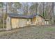 Charming single story home featuring a stone facade, light yellow siding, and mature trees surrounding the property at 4716 Habersham Sw Rdg, Lilburn, GA 30047