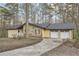 Home featuring stone facade, light yellow siding, attached two-car garage and long driveway at 4716 Habersham Sw Rdg, Lilburn, GA 30047