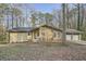 Single-story home with stone facade and attached two car garage set amongst mature trees at 4716 Habersham Sw Rdg, Lilburn, GA 30047