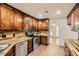 Kitchen featuring stainless appliances, a decorative tile backsplash and stained wood cabinets at 4716 Habersham Sw Rdg, Lilburn, GA 30047