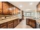 Kitchen featuring stained cabinets, brick flooring, stainless appliances and large windows at 4716 Habersham Sw Rdg, Lilburn, GA 30047