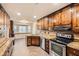 Kitchen featuring dark wood cabinets, stainless steel appliances, and brick flooring at 4716 Habersham Sw Rdg, Lilburn, GA 30047