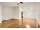 Living room featuring hardwood floors, white walls, a ceiling fan, and a sliding barn door at 4716 Habersham Sw Rdg, Lilburn, GA 30047