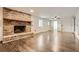 Spacious living room with brick fireplace, wood mantle, and wood-look tile flooring at 4716 Habersham Sw Rdg, Lilburn, GA 30047
