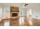 Spacious living room features gleaming hardwood floors and a brick fireplace at 4716 Habersham Sw Rdg, Lilburn, GA 30047