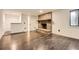 Open living area featuring a classic brick fireplace and modern wood-look tile floors at 4716 Habersham Sw Rdg, Lilburn, GA 30047