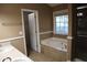 Bathroom featuring soaking tub with tile surround, separate shower, and double vanity sink at 1313 Idlewood Ct, Mcdonough, GA 30252