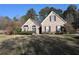 Beautifully landscaped front yard with mature trees, offering shade and curb appeal to this inviting home at 1313 Idlewood Ct, Mcdonough, GA 30252