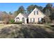 Beautiful single-Gathering home with brick facade, mature trees, and landscaped front yard at 1313 Idlewood Ct, Mcdonough, GA 30252