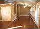 Open-concept living room with hardwood floors, ceiling fan, and a patio door leading to outdoor space at 1313 Idlewood Ct, Mcdonough, GA 30252