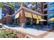 Charming bakery exterior with yellow awnings, outdoor seating, and well-maintained landscaping at 1923 Deco Dr, Kennesaw, GA 30144