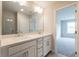 Bathroom with double sinks, framed mirror and a view into another room at 1923 Deco Dr, Kennesaw, GA 30144