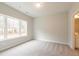 Bright bedroom with a large window, neutral carpet and an attached bath at 1923 Deco Dr, Kennesaw, GA 30144
