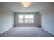 Bedroom features neutral paint, plush carpet, large windows, and overhead lighting at 1923 Deco Dr, Kennesaw, GA 30144