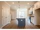Spacious kitchen boasts stainless steel appliances, a gray island and white cabinets at 1923 Deco Dr, Kennesaw, GA 30144