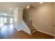 Staircase has wood stairs, white risers, and a black metal decorative banister and stained handrail at 1923 Deco Dr, Kennesaw, GA 30144