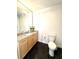 Modern bathroom boasts a granite countertop, elegant light fixture, and contrasting black tile floor at 325 E Paces Ferry Ne Rd # 1606, Atlanta, GA 30305