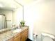 Well-lit bathroom with granite countertops, a decorative mirror, and ceramic sink basin at 325 E Paces Ferry Ne Rd # 1606, Atlanta, GA 30305