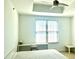 Bedroom featuring a large bright window, desk area, ceiling fan, and a neutral color palette at 325 E Paces Ferry Ne Rd # 1606, Atlanta, GA 30305