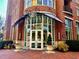 Beautiful brick building with glass facade, manicured landscaping, and elegant entrance at Paces Park at 325 E Paces Ferry Ne Rd # 1606, Atlanta, GA 30305
