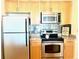 Well-equipped kitchen with wooden cabinets, stainless steel appliances, and granite countertops offering an eat in space at 325 E Paces Ferry Ne Rd # 1606, Atlanta, GA 30305
