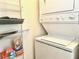 Efficient laundry area with stacked washer/dryer unit and convenient shelving at 325 E Paces Ferry Ne Rd # 1606, Atlanta, GA 30305