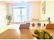 Bright living room featuring a modern table with fruit, sleek shelving, and a large window for natural light and city views at 325 E Paces Ferry Ne Rd # 1606, Atlanta, GA 30305