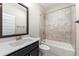 A well-lit bathroom features a shower and tub combo with decorative tile and a dark vanity with a white sink at 513 Broadview Ln, Atlanta, GA 30324