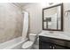 A serene bathroom boasts a shower with a tub, and a dark vanity with a sink, creating a relaxing space at 513 Broadview Ln, Atlanta, GA 30324