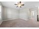 Large bedroom with carpet flooring, neutral colored walls and trim, and a ceiling fan at 513 Broadview Ln, Atlanta, GA 30324