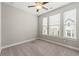 Bright bedroom featuring neutral walls, carpet flooring, a ceiling fan, and lots of natural light through multiple windows at 513 Broadview Ln, Atlanta, GA 30324