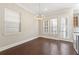 Dining area featuring hardwood floors, chandelier, and access to the balcony through glass doors at 513 Broadview Ln, Atlanta, GA 30324