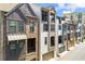 Exterior view showcases a row of modern townhomes each with unique architectural details at 513 Broadview Ln, Atlanta, GA 30324