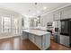 Spacious kitchen with an island, stainless steel appliances, gray cabinets, and an open layout at 513 Broadview Ln, Atlanta, GA 30324