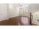 Spacious living room with dark hardwood floors, large windows, and a ceiling fan at 513 Broadview Ln, Atlanta, GA 30324