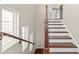 Elegant staircase with hardwood steps and a dark wood railing, offering a classic design at 513 Broadview Ln, Atlanta, GA 30324