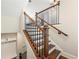 Elegant staircase with hardwood treads, white risers, and wrought iron balusters leading to the upper level at 513 Broadview Ln, Atlanta, GA 30324