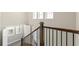A modern staircase with a dark wood banister leads to the upper level of the home, illuminated by bright windows at 513 Broadview Ln, Atlanta, GA 30324