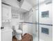 Charming bathroom featuring a glass shower, stacked washer/dryer, and modern fixtures at 3016 Ansley Manor Ct, Snellville, GA 30078