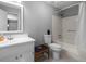 Well-lit bathroom featuring a vanity, toilet, and tub-shower combination with modern fixtures at 3016 Ansley Manor Ct, Snellville, GA 30078