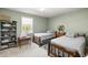 Comfortable bedroom featuring two twin beds, a window, and ample closet space at 3016 Ansley Manor Ct, Snellville, GA 30078