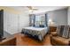 Spacious bedroom with hardwood floors, a ceiling fan, and double closets at 3016 Ansley Manor Ct, Snellville, GA 30078
