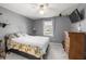 Cozy bedroom with carpet, a ceiling fan, and a television on an antique dresser at 3016 Ansley Manor Ct, Snellville, GA 30078