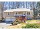 Charming split-level home with metal roof, front porch, deck, and two-car garage at 3016 Ansley Manor Ct, Snellville, GA 30078