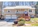 Charming split-level home with metal roof, front porch, deck, and two-car garage at 3016 Ansley Manor Ct, Snellville, GA 30078
