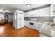 Traditional-style kitchen features white cabinetry, stainless appliances, and open access to living space at 3016 Ansley Manor Ct, Snellville, GA 30078