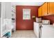 Well-organized laundry room with storage shelves, a window, and a washer and dryer set at 3016 Ansley Manor Ct, Snellville, GA 30078