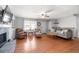 Bright and airy living room featuring hardwood floors, stone fireplace, and neutral paint at 3016 Ansley Manor Ct, Snellville, GA 30078