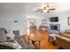Spacious living room features a fireplace, hardwood floors, and modern ceiling fan at 3016 Ansley Manor Ct, Snellville, GA 30078