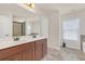 Bright bathroom with a double sink vanity and framed mirror at 5711 Keys Way, Lithonia, GA 30058
